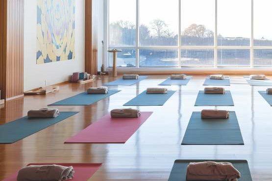 The yoga hall, mats laid out beneath tall windows