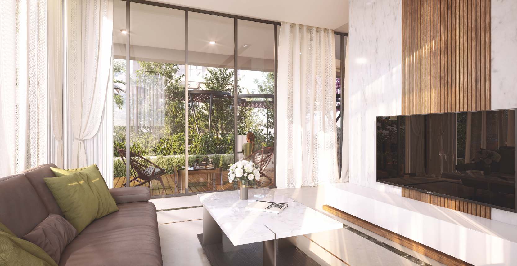 Living room opening to the garden through full-height glass.